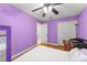 Bedroom featuring hardwood floors, a ceiling fan, and a spacious closet for ample storage at 2042 Hayfield Way, Apopka, FL 32712