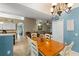 Open dining room with chandelier, a view of the living room, and backyard access at 2042 Hayfield Way, Apopka, FL 32712