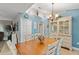 Dining area features a decorative china cabinet and chandelier lighting at 2042 Hayfield Way, Apopka, FL 32712