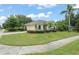 Charming exterior view showcasing lush landscaping and a well-maintained lawn on a sunny day at 2042 Hayfield Way, Apopka, FL 32712