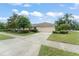 Attractive single-story home with a well-manicured lawn and paved driveway at 2042 Hayfield Way, Apopka, FL 32712