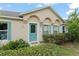 Charming home with arched entryway, decorative door, and manicured front yard at 2042 Hayfield Way, Apopka, FL 32712