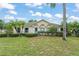 Inviting single story home featuring a well-manicured lawn, mature landscaping, and a charming blue front door at 2042 Hayfield Way, Apopka, FL 32712