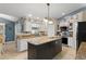 Kitchen showcasing a central island with granite countertop, appliances and white cabinetry at 2042 Hayfield Way, Apopka, FL 32712