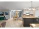 Open-concept kitchen featuring an island, dining area, and modern decor at 2042 Hayfield Way, Apopka, FL 32712