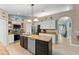 Bright kitchen with a central island, stainless steel appliances, and ample counter space at 2042 Hayfield Way, Apopka, FL 32712
