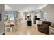 Eat in kitchen boasts granite countertops, white cabinetry, and island at 2042 Hayfield Way, Apopka, FL 32712