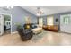 Inviting living room with tile floors, high ceiling, comfortable seating, and stylish décor at 2042 Hayfield Way, Apopka, FL 32712