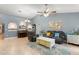Cozy living room with tile floors, a ceiling fan, a modern rug, and colorful decor at 2042 Hayfield Way, Apopka, FL 32712