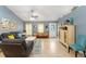 Bright living room with tile floors, a ceiling fan, light blue walls, and comfortable seating at 2042 Hayfield Way, Apopka, FL 32712