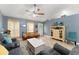Open-concept living room featuring tile floors, neutral paint, and an abundance of natural light at 2042 Hayfield Way, Apopka, FL 32712