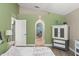 Bright bedroom with hardwood floors, neutral walls, a large dresser, and a glimpse of an ensuite bathroom at 2042 Hayfield Way, Apopka, FL 32712