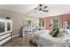 Serene bedroom featuring hardwood floors, neutral walls, and a floral patterned bedspread at 2042 Hayfield Way, Apopka, FL 32712