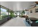 Covered patio offering natural light, plenty of plants, and comfortable seating for outdoor enjoyment at 2042 Hayfield Way, Apopka, FL 32712