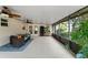Covered patio features plenty of light, plants, and comfortable seating for relaxation and outdoor gatherings at 2042 Hayfield Way, Apopka, FL 32712