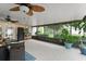 Enclosed patio filled with natural light, potted plants, and comfortable seating for relaxation at 2042 Hayfield Way, Apopka, FL 32712