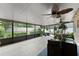 Enclosed patio filled with natural light, plants, and comfortable seating for outdoor living at 2042 Hayfield Way, Apopka, FL 32712