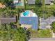 Overhead view of home with a pool and a circular driveway, surrounded by mature trees in a residential neighborhood at 2220 Derbyshire Rd, Maitland, FL 32751