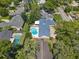 Stunning aerial view of a charming home with a sparkling blue pool and lush green landscaping at 2220 Derbyshire Rd, Maitland, FL 32751