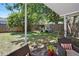 View of the fenced in backyard with lawn, trees and covered patio area at 2220 Derbyshire Rd, Maitland, FL 32751