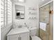 Bathroom with a glass-enclosed shower, marble countertop, and ample shelving at 2220 Derbyshire Rd, Maitland, FL 32751