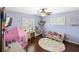 Charming bedroom featuring hardwood floors, a play tent, and plenty of natural light at 2220 Derbyshire Rd, Maitland, FL 32751