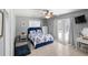Bright bedroom with a blue bed, white furniture, and a door to the backyard at 2220 Derbyshire Rd, Maitland, FL 32751