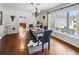 Dining room featuring hardwood floors, a large window, and an elegant chandelier at 2220 Derbyshire Rd, Maitland, FL 32751