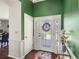 Welcoming entryway with decorative glass door, accent walls, and hardwood flooring at 2220 Derbyshire Rd, Maitland, FL 32751