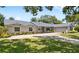 Charming single-story home with well-maintained landscaping and inviting curb appeal at 2220 Derbyshire Rd, Maitland, FL 32751