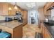 Kitchen with wood cabinets, granite counters and tile flooring at 2220 Derbyshire Rd, Maitland, FL 32751