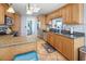 Kitchen showcasing wood cabinets, a stylish backsplash, and modern stainless steel appliances at 2220 Derbyshire Rd, Maitland, FL 32751