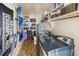 Functional laundry room with modern washer and dryer, shelving and tile flooring at 2220 Derbyshire Rd, Maitland, FL 32751