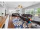 Spacious living room with wood floors, ceiling fan, and sliding glass doors to the patio at 2220 Derbyshire Rd, Maitland, FL 32751