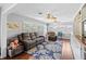 Cozy living room with ample seating, wood floors, and large windows for natural light at 2220 Derbyshire Rd, Maitland, FL 32751