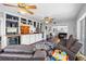 Open-concept living room featuring wood floors, built-in shelves, and comfortable seating at 2220 Derbyshire Rd, Maitland, FL 32751