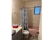 Bathroom with pink tiles, matching pink bath tub, new vanity and a window at 2302 Greenwood St St, Deltona, FL 32738