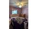 Bedroom with a ceiling fan, dresser, queen bed and window at 2302 Greenwood St St, Deltona, FL 32738