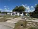 Modest single-story home with a chain-link fence and a covered carport at 2302 Greenwood St St, Deltona, FL 32738