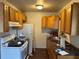 Kitchen with tile floor, granite counters, white appliances and wood cabinets at 2302 Greenwood St St, Deltona, FL 32738