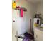 Utility area featuring a water heater, washer, dryer, and storage shelving at 2302 Greenwood St St, Deltona, FL 32738