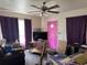Living room with carpet floor, ceiling fan, purple curtains and pink door at 2302 Greenwood St St, Deltona, FL 32738