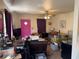 This living room has carpet floor, ceiling fan, purple curtains and pink door at 2302 Greenwood St St, Deltona, FL 32738