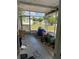 Enclosed porch area filled with stored items, offering potential for renovation at 2302 Greenwood St St, Deltona, FL 32738