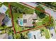 Aerial view of a home with a screened pool, solar panels and a large backyard with boundary lines at 245 Meadow Bay Ct, Lake Mary, FL 32746
