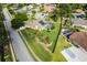Overhead view of house featuring its screened pool, solar panels, and beautiful landscaping at 245 Meadow Bay Ct, Lake Mary, FL 32746