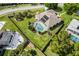 Aerial view featuring a screened pool, solar panels and large yard with a privacy fence at 245 Meadow Bay Ct, Lake Mary, FL 32746