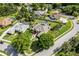 Overhead view of the house showcasing its screened pool, solar panels, and beautiful landscaping at 245 Meadow Bay Ct, Lake Mary, FL 32746