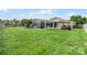 Expansive backyard featuring a lush lawn, screened-in pool area, and hot tub, perfect for outdoor enjoyment at 245 Meadow Bay Ct, Lake Mary, FL 32746