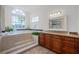 Bathroom featuring a soaking tub with jets, granite vanity, and walk-in shower at 245 Meadow Bay Ct, Lake Mary, FL 32746